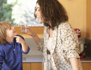 women and kid drinking water